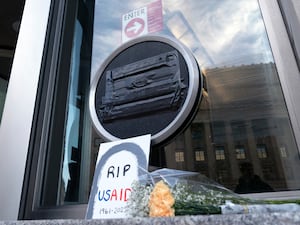 Flowers and a sign outside the headquarters of the US Agency for International Development