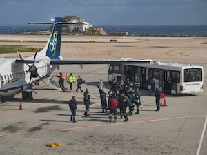 Fire service rescuers arrive at the airport of the earthquake-hit island of Santorini