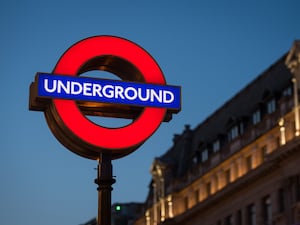 London Underground sign lit up at night