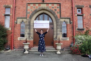 Bells Lewers with cheque for Cancer Research UK after Ellesmere College concert 