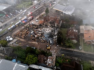 Police carry out an investigation by houses that were hit by a plane in Gramado, Rio Grande do Sul State, Brazil