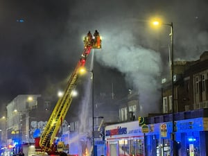 Firefighters at the scene of a fire at a takeaway restaurant in Holloway, north London