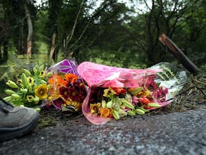 Flowers left on the roadside at the scene of a fatal crash