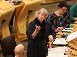 Shona Robison standing while speaking in Holyrood