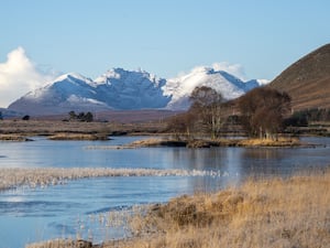 Loch in foreground with wintry hills in background