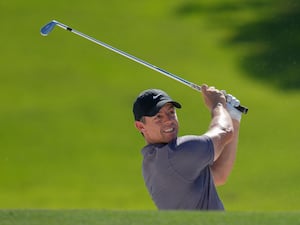 Rory McIlroy watches his bunker shot