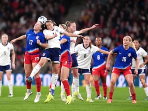 USA’s Sam Coffey and England’s Fran Kirby battle for the ball