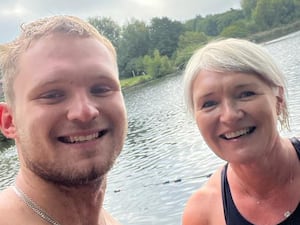 Kate and Archie Vokes smiling at a lake