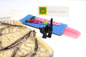 Items, including a lucky black cat figurine from Joan’s handbag.