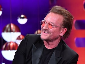 A close-up of Bono smiling