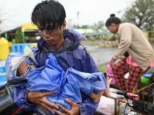 Residents arrive at a school used as a temporary evacuation centre