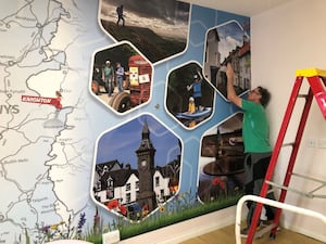 A mural being installed.