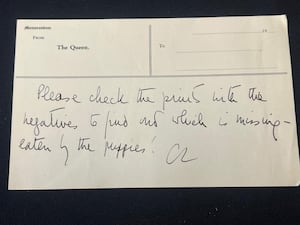 The note written by the late Queen Elizabeth II to photographer Alan Maxwell explaining that her dogs had eaten a picture