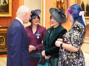 Georgie Laurie and her sister Melissa with the King at the Palace