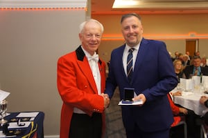 Jay Showell receives the Amateur Championship medal from Shropshire & Herefordshire president Charles Sievewright