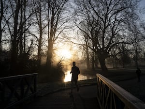 A jogger running in a cold park