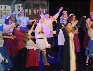 Anna Percy as Lady Guinevere with chorus members