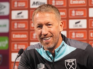 Graham Potter laughs as he speaks to the media