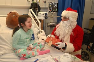 Santa, with Mary Ellen Connor, 7, from Telford