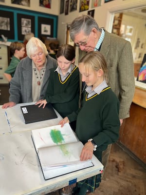 Lily and Rosie show their grandparents around the Art Room