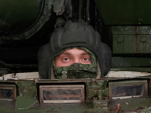 A Russian soldier drives a T-80BVM tank