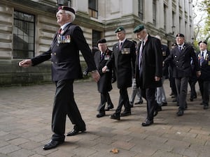 Veterans march down a street