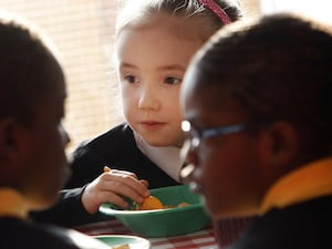 Children eat breakfast at school