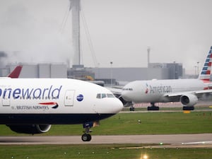 A British Airways Boeing B777-200ER and an American Airlines Boeing B777-300ER on the taxiway at Heathrow Airport