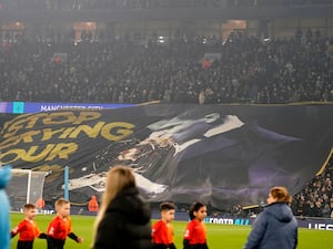 Manchester City’s fans hold up a banner reading 'Stop crying your heart out' with a picture of Rodri kissing the Ballon d'Or trophy, before the Champions League clash with Real Madrid