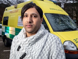 Umran Ali Javaid standing in front of an ambulance