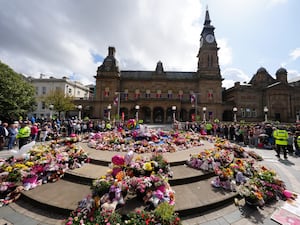 Flowers and tributes outside the Atkinson Art Centre, Southport (Owen Humphreys / PA)