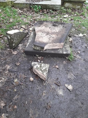 The smashed gravestone.