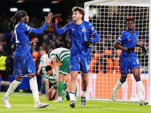 Marc Guiu celebrates by high-fiving a team-mates after scoring Chelsea's opening goal