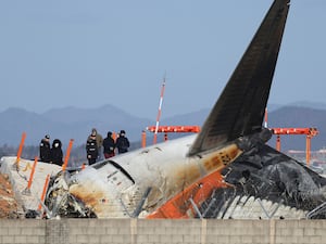 Transportation Safety Board experts check the site of the crash at Muan International Airport