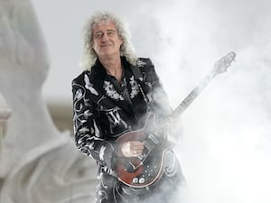 Brian May playing a guitar