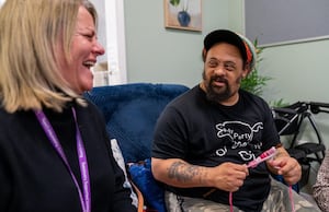 Local Service Manager, Melissa Knox, shares a moment of laughter with Nathan as he works on his crochet project.