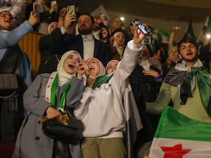 Syrians sing and wave post-Assad flags during the concert