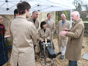 The King speaks with students as he admires their work