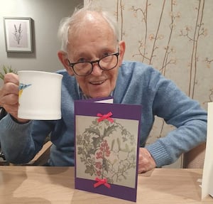 David Housden with a card he produced for King Charles and Queen Consort Camilla