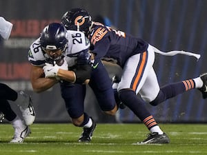 Seattle Seahawks running back Zach Charbonnet is tackled by Chicago Bears cornerback Tyrique Stevenson