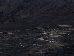 An Israeli bulldozer maneuvers on the buffer zone near the so-called Alpha Line that separates the Israeli-controlled Golan Heights from Syria, viewed from the town of Majdal Shams