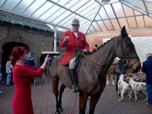 Robert Jones, senior joint master of the Radnor and West Herefordshire Hunt takes a warming drink from Burton Hotel owner Jana Hyde.