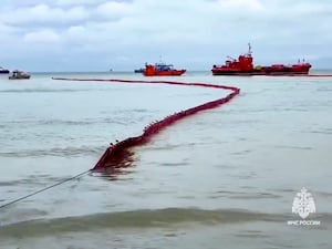 Booms on the sea around a damaged tanker ear the port of Taman