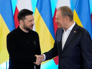 Volodymyr Zelensky and Donald Tusk shake hands