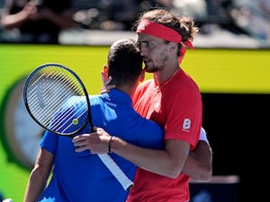 Alexander Zverev embraces Novak Djokovic