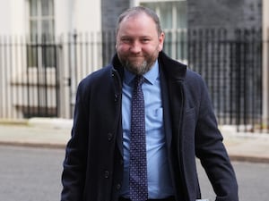 Ian Murray smiling while walking on Downing Street