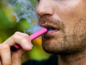 A man uses a disposable vape