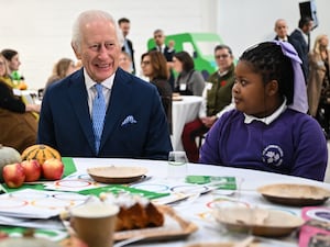 The King chats with a local schoolgirl during a visit to the Coronation Food Project's hub in Deptford, south-east London