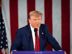 Donald Trump in front of a podium as he speaks on stage at a campaign rally in Waukesha, Wisconsin.