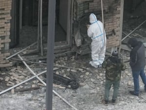 Investigators work at the place where Lt General Igor Kirillov was killed